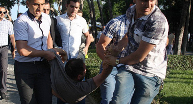 Azerbaijan, Baku, May 25, 2012: men in civilian clothes detain participants of promenade in Primorskiy Boulevard. Courtesy of the IA "Turan"