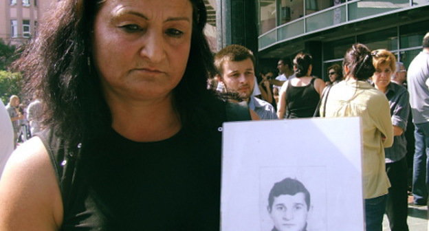 

Manana Abuseridze with a photo of her brother, who died from torture in Gldani Prison, Tbilisi, September 19, 2012. Photo by Edita Badasyan for the "Caucasian Knot"