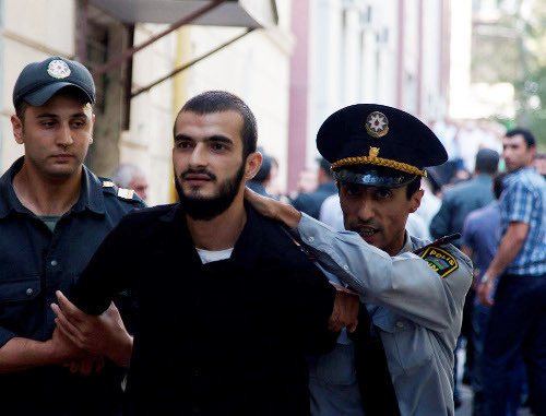 Policemen detaining believer-protester against the ban on wearing hijabs in schools; Azerbaijan, Baku, October 5, 2012. Photo by Aziz Karimov for the "Caucasian Knot"