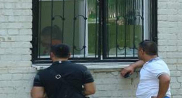 Fathers of infected children comunicate with their wives through the bars in the windows of the infection ward of the Central City Hospital of Rostov-on-Don; June 2013. Courtesy of the  http://donnews.ru