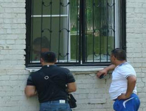 Fathers of infected children comunicate with their wives through the bars in the windows of the infection ward of the Central City Hospital of Rostov-on-Don; June 2013. Courtesy of the  http://donnews.ru