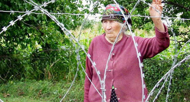 Valya Vanishvili near barbed wire which separated her house from the rest ones. Village Didi Khurvaleti of Gori District, Georgia, July, 2013. Photo by Edita Badasyan for the "Caucasian Knot"