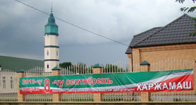 Poster about forthcoming local parliamentary elections of Chechnya of the third convocation on fence of Mosque. July 2013. Photo by the press cutting service of Chechnya election committee, http://www.chechen.izbirkom.ru/