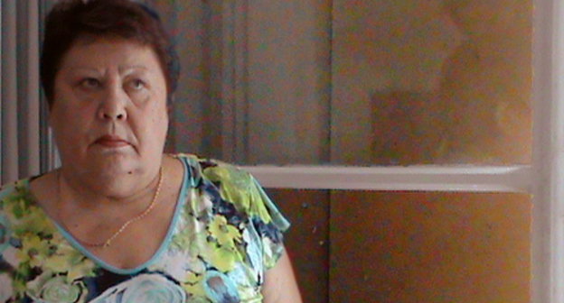 Galina Balakhonova, a kindergarten guard, near the window broken by vandals. Volgograd, August 27, 2013. Photo by Vyacheslav Yaschenko for the "Caucasian Knot"