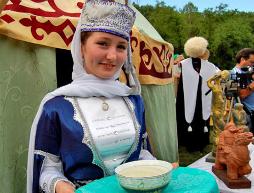 Girl in a traditional costume at the Karachay-Cherkessia cuisine exhibition presented at the youth forum of the North-Caucasian Federal District "Mashuk-2012". Pyatigorsk, July 10, 2013. Photo: official site of the head of the republic, http://www.kchr.ru/