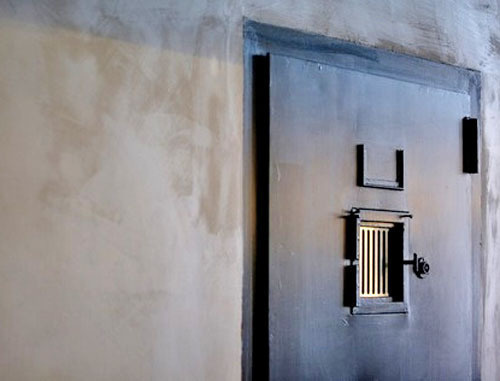 Door to a prison cell. Photo by user arnedielis, Flickr.com