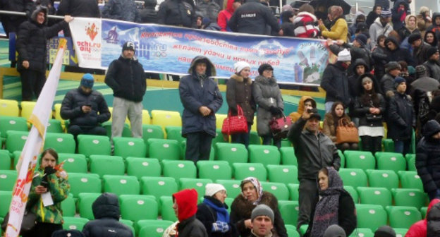 Spectators in the stalls of of the "Anji Arena" during the ceremony of honouring the Olympic Flame. Dagestan, January 27, 2014. Photo http://www.anji-arena.ru/olimpijskij-ogon-na-anzhi-arene/