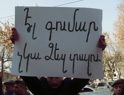 Participant of the rally in protest of the new pension system holding billboard ‘No more money to give out to you’, Yerevan, February 6, 2014. Photo by Armine Martirosyan for the ‘Caucasian Knot’. 