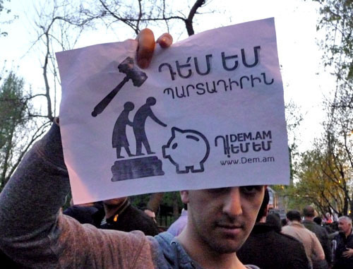 Participant of the action against the pension reform holds a poster "I'm against the mandatory component". Yerevan, April 18, 2014. Photo by Armine Martirosyan for the "Caucasian Knot"