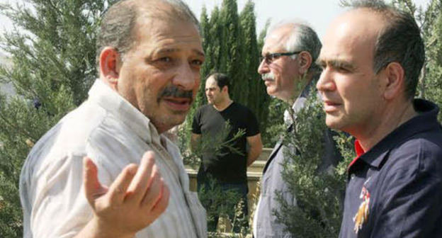 Rauf Mirkadirov (to the left) at the funeral of his father. Baku, May 24, 2014. Photo IA "Turan"