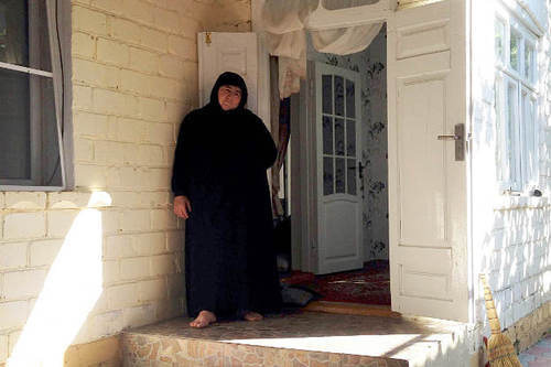 The village of Maidanskoe, Untsukul District of Dagestan, July 2014. Ayna Gamzatova, mother of the villager Magomed Payzulaev killed during the special operation on July 6, 2014, in the door of her house. Photo by Makhach Akhmedov for the "Caucasian Knot"