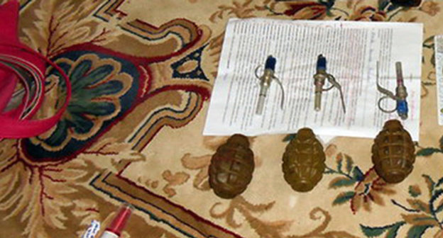 A hand grenade on a carpet in a house. Photo http://nac.gov.ru/files/2278.JPG