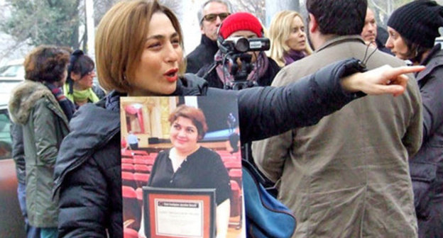 Nino Daneliya, a participant of the action, holds a poster with the photo of the journalist Khadija Ismayilova. Tbilisi, December 10, 2014. Photo by Edita Badasyan for the "Caucasian Knot