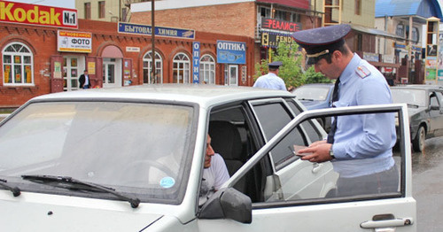 Law enforcement officer checking documents. Photo: MIA of Ingushetia, http://06.mvd.ru