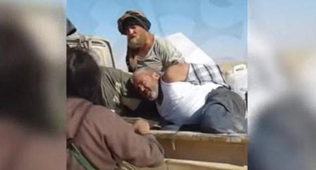 Still picture from the video showing captivity of the Cossack Roman Zabolotniy in Syria: https://www.youtube.com/watch?v=2QkDaZNGxsY