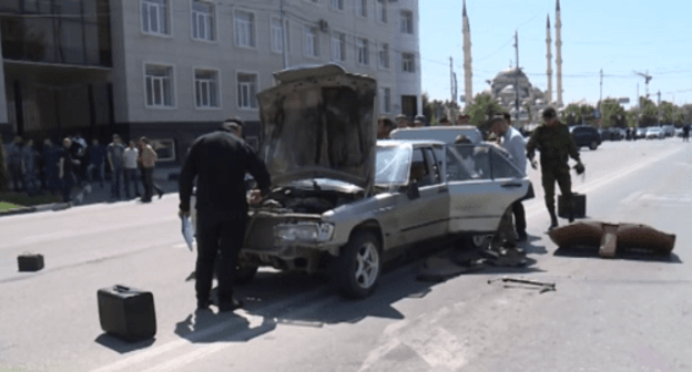 Law enforcers inspecting a car used in a series of attacks on police officers in Grozny. Screenshot of the Grozny TV Channel https://www.youtube.com/watch?v=20PJ1P7dsGY