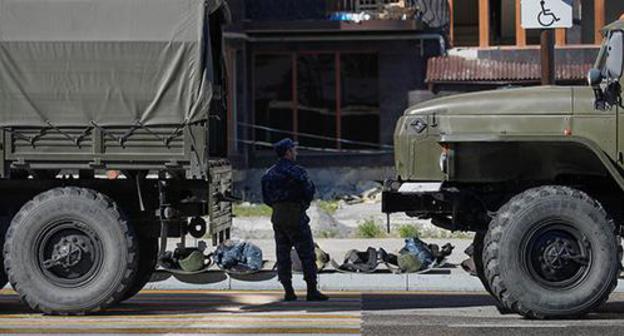 Law enforcer standing near military vehicles, Magas, October 2018. Photo: REUTERS/Maxim Shemetov