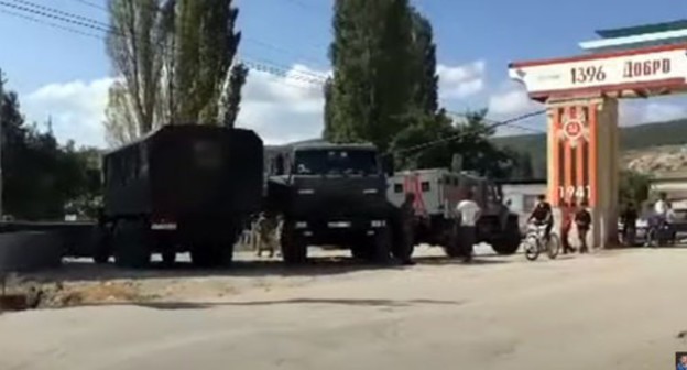 Law enforcers near the Gubden village in Dagestan. Screenshot of the video by Ruslan Kurbanov "СРОЧНО: Военные в Дагестане введены в село с техникой" https://www.youtube.com/watch?v=-fhzcXBLrWc&amp;feature=emb_logo