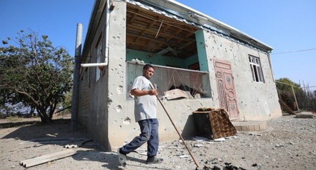 Natig Garaev, a resident of the Agdam District, near the house damaged by shelling. Photo by Aziz Karimov for the "Caucasian Knot"