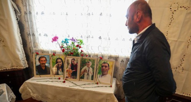 Teimur Askerov standing next to the photos of his perished relatives. October 22, 2020. Photo by Aziz Karimov for the "Caucasian Knot"