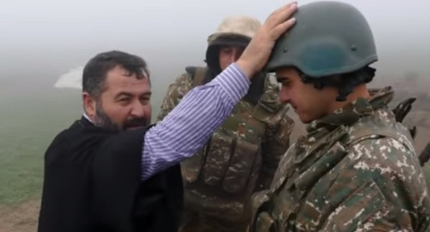 The priest blessed Armenian soldiers in the trenches. Screenshot of the video posted on YouTube ВООРУЖЕННЫЕ СИЛЫ MEDIA https://www.youtube.com/watch?v=FGXc0hWqj5M&amp;t=1s