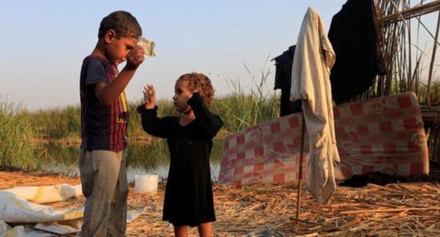 Children playing in the Chebayesh bog, Dhi Qar province, Iraq. Photo: REUTERS / Thayer al-Sudani