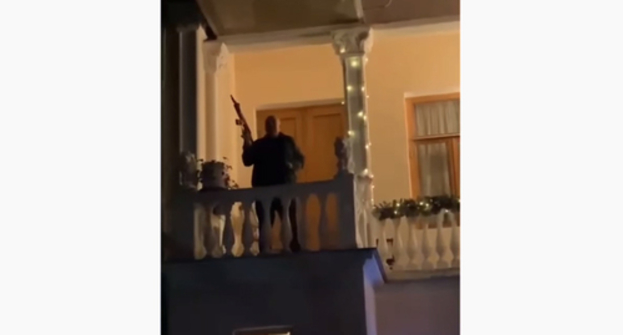 An armed man on the balcony of a Sukhumi restaurant, where a man was wounded. Screenshot: https://www.youtube.com/channel/UC2M9C6PmcXOfjzEP305TyZA