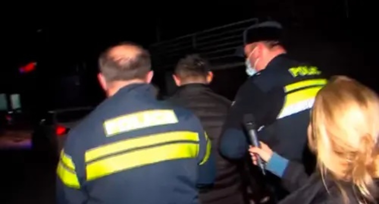 Police take away the attacker on journalists. Image made from video posted by Formula channel at: https://formulanews.ge/News/66843