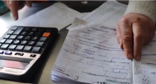 Notebook of debtors in a store in Chechnya. Image made from video posted by ChGTRK ‘Grozny’ https://www.youtube.com/watch?time_continue=115&amp;v=5u_7-1_-E4g&feature=emb_logo
