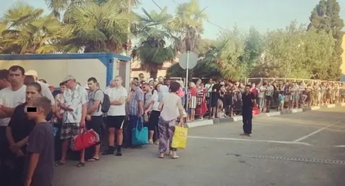 People stand in line at the ‘Psou’ border checkpoint. Screenshot: https://www.ntv.ru/novosti/646277/