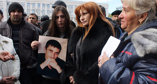 Vladimir Tskaev's relatives holding his photo near the building of the Government of North Ossetia–Alania. Photo: https://twitter.com