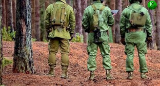 Militaries standing in a forest. Picture made in Photoshop by the "Caucasian Knot"